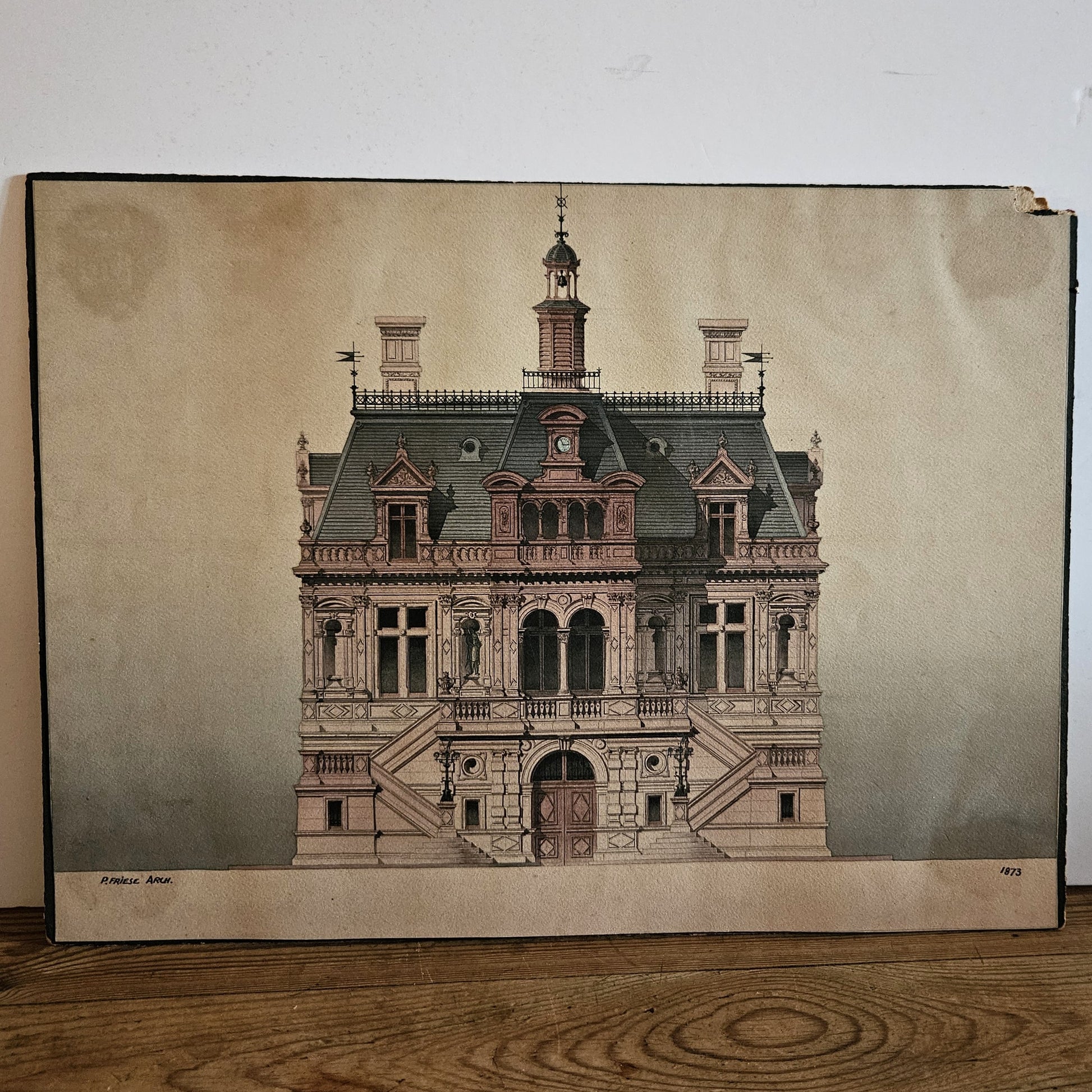 Aquarelle originale de Paul Friesé architecte, représentant la façade d'un édifice Second Empire avec clocheton à dôme, horloge en lucarne et balustrades en fer forgé, datée 1873, dans un cadre en bois noirci, posée sur un parquet en bois brut.