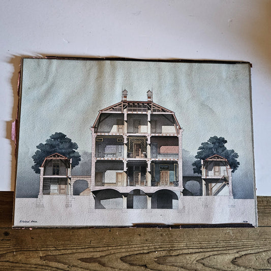Aquarelle originale polychrome encadrée de Paul Friesé, représentant la coupe transversale d'un édifice monumental Renaissance avec quatre espaces intérieurs distincts et un pavillon de jardin à droite, signée P. FRIESÉ ARCH. et datée 1878, posée sur une table en bois brut.