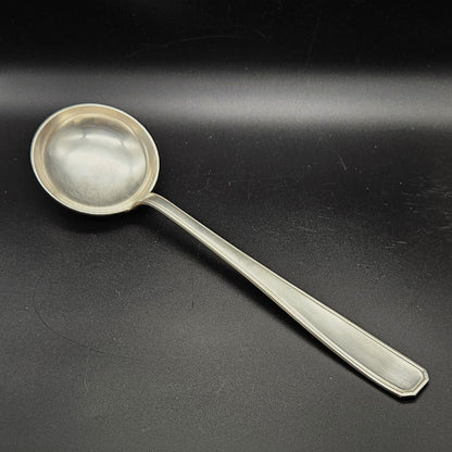 Louche à potage en métal argenté modèle de la Maison Boulenger Paris, 33,7 cm, vue de face sur fond noir, montrant la cuillère ronde et profonde avec bourrelet périphérique et le manche rectangulaire à filet périphérique unique avec extrémité à pans coupés octogonaux.
